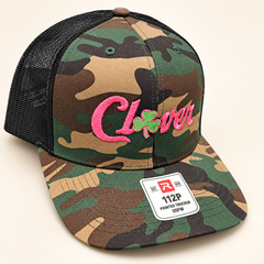Clover hat 2 Richardson 112P camo with black mesh pink lettering and small green clover