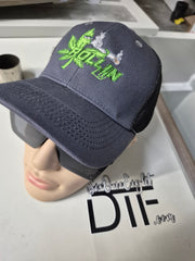 Rollin Lit green embroidered logo on gray and black six-panel trucker hat