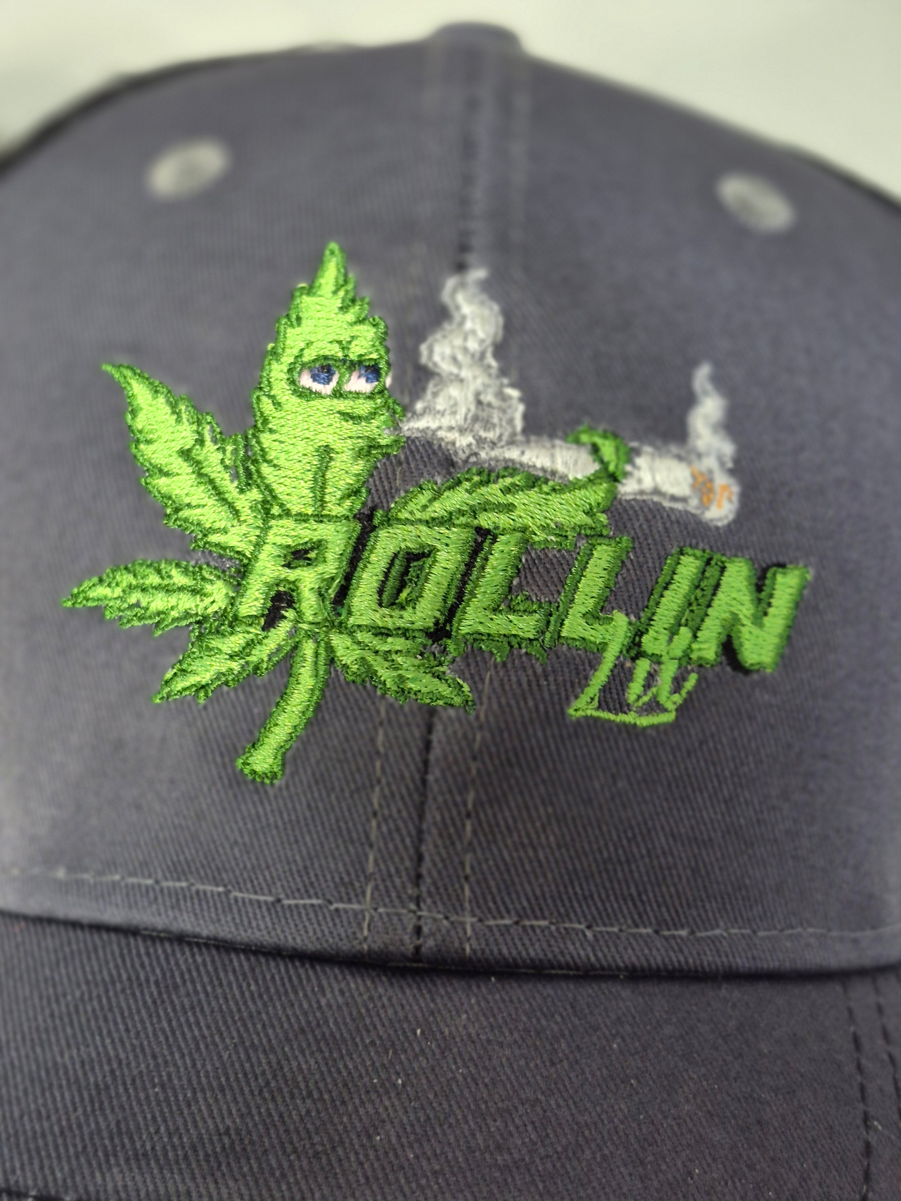 Rollin Lit green embroidered logo on gray and black six-panel trucker hat