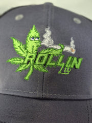 Rollin Lit green embroidered logo on gray and black six-panel trucker hat