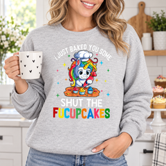 Woman wearing Shut the Fucupcakes unicorn baker sweatshirt